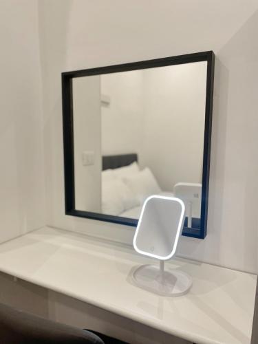 a white chair sitting on a counter in front of a mirror at THE ROOM 115 in Rome