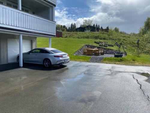 a car parked in front of a garage at Charming apartment in Meråker in Meråker