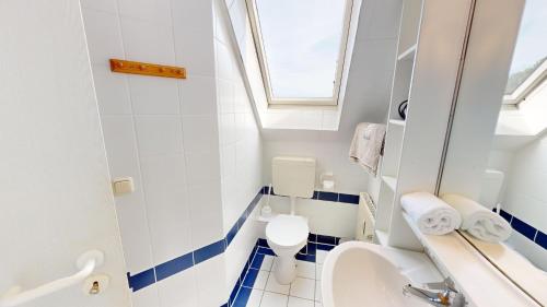 ein kleines Bad mit WC und Waschbecken in der Unterkunft Sonnenhügel App. 08 in Grömitz