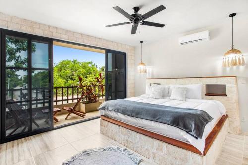 a bedroom with a bed and a balcony at Old Listing - Selva 5 in Tulum