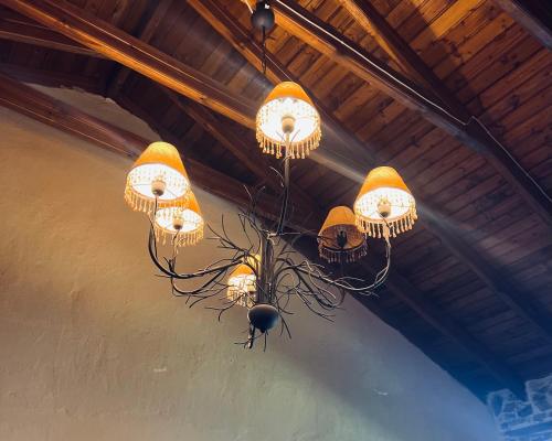 a chandelier with lights hanging from a ceiling at Villa Tzeni Palios Panteleimon in Panteleímon