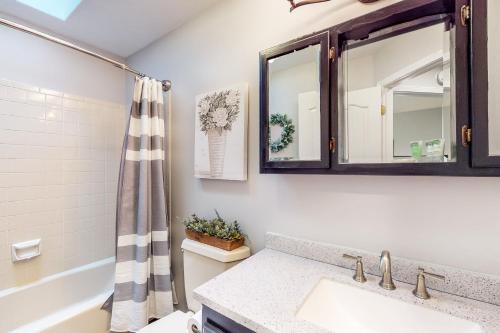 a bathroom with a sink and a mirror at Apple Cottage 