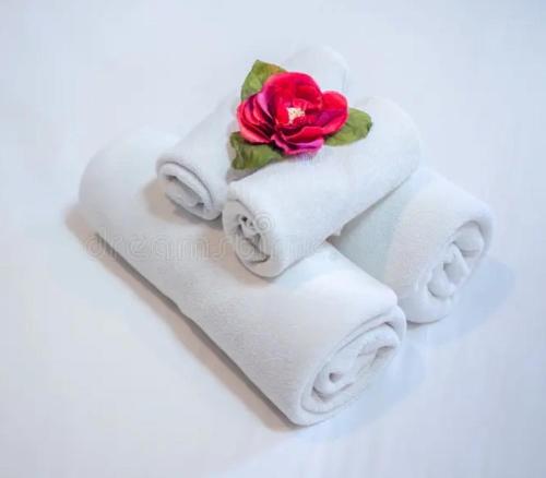 a stack of towels with a rose on top at Vallecorsa city in Vallecorsa