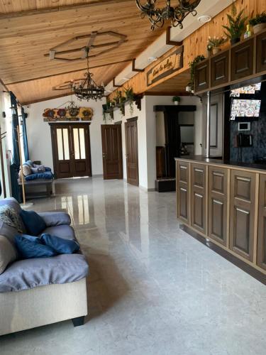 a large living room with a couch and wooden ceilings at RELAX COMPLEX HOTEL in Boryspilʼ