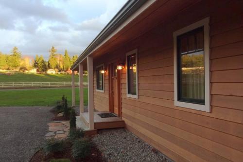 a wooden house with a door and a window at Woodinville's Hollywood Hill Guest House in Woodinville