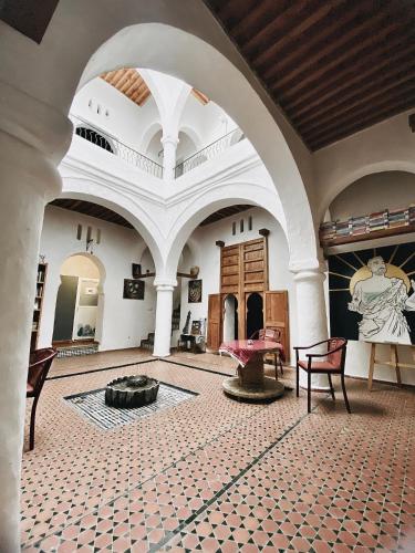 a large room with a fountain in the middle of a building at Tarbi'aat Tetaoun 44, 17th century heritage in Tetouan