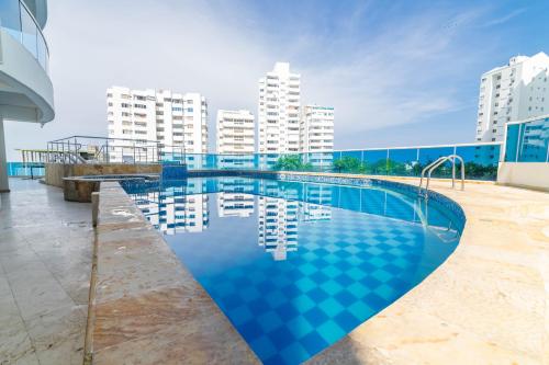 a large swimming pool with buildings in the background at Apartamento Unik Cartagena Edificio Poseidón in Cartagena de Indias