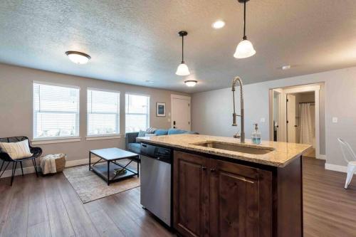 a kitchen with a sink and a living room at Sleepy Ridge Apt in Vineyard/Orem (Sleeps 6) in Orem