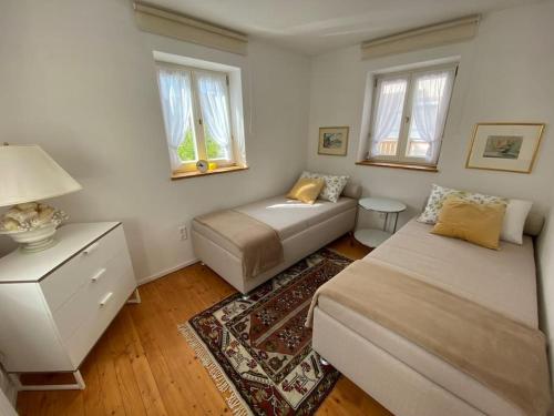 a bedroom with two beds and a couch and windows at Ferienhaus mit Garten und Balkon in Berching