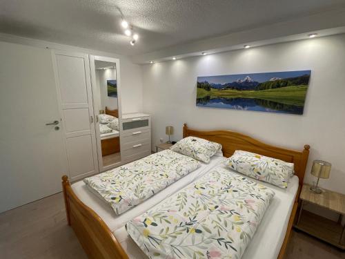 a bedroom with two beds and a painting on the wall at Ferienwohnung Rose in Villingen-Schwenningen