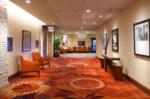 a lobby with chairs and a rug on the floor at Seattle Airport Marriott in SeaTac