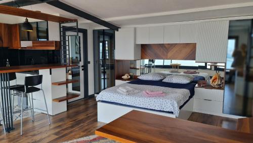a bedroom with two beds and a kitchen and a table at Fascinating Sea View in İzmir