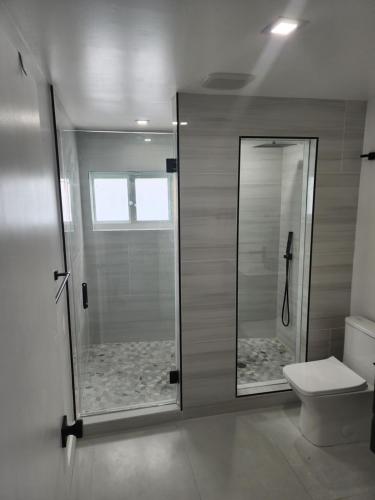 a bathroom with a shower and a toilet at JBMANORS in Fort Lauderdale