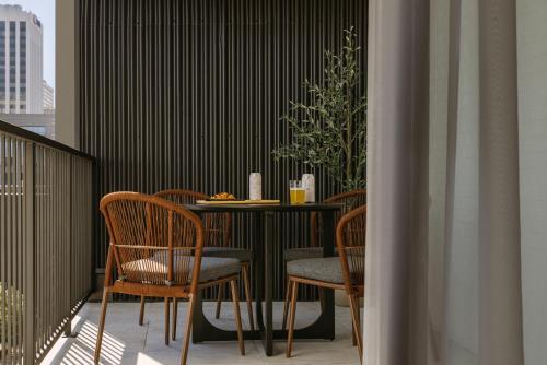 a balcony with a table and chairs on a balcony at Sonder The Fitz in Saint Paul