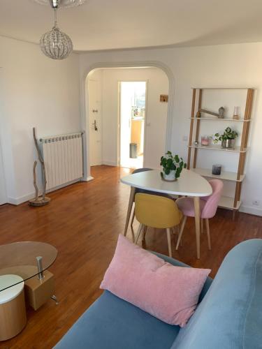 a living room with a table and a table and a couch at Appartement T3 Anglet 67m2 in Anglet