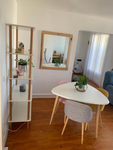 a living room with a table and a table and chairs at Appartement T3 Anglet 67m2 in Anglet
