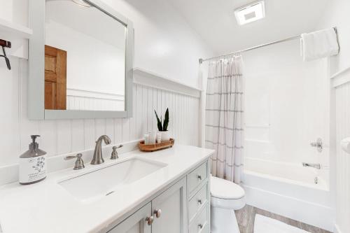 a white bathroom with a sink and a mirror at Firefly Ridge in Townsend