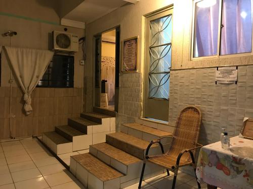 a set of stairs in a room with a table and chairs at Hotel Belo Jardim in Hortolândia