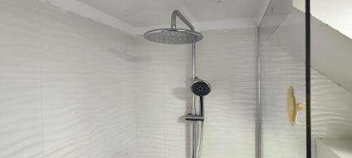 a shower with a shower head in a bathroom at Sonora Aircon Bungalow 121 in Maspalomas