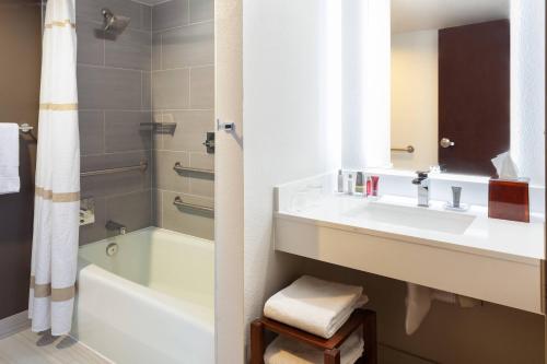 a bathroom with a sink and a bath tub at Marriott Albuquerque in Albuquerque