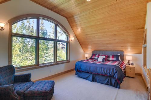 a bedroom with a bed and a chair and windows at Mountain Home about 5 Mi to Winter Park Resort! in Winter Park