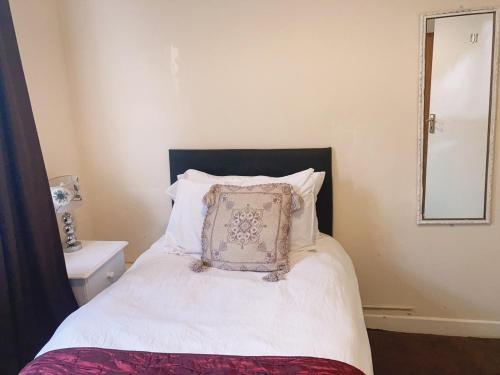 a bedroom with a bed with a pillow on it at Mulgrave Lodge in Dun Laoghaire