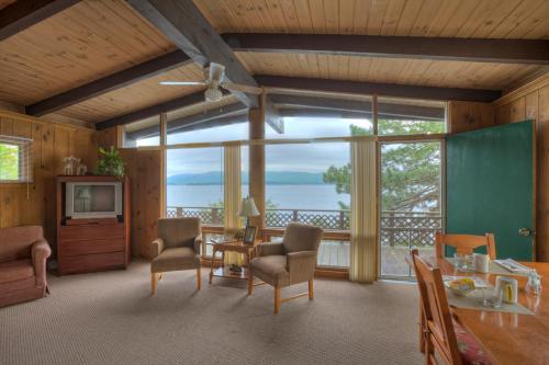 a living room with a view of the water at Sun Castle Resort in Lake George
