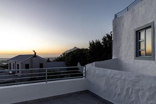 a view of the sunset from the balcony of a house at Capri Sands Luxury Guest House in Capri Village