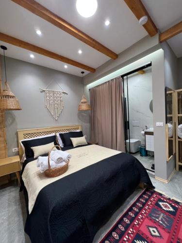 a bedroom with a large bed and a bathroom at Guesthouse Villa Gurra in Theth