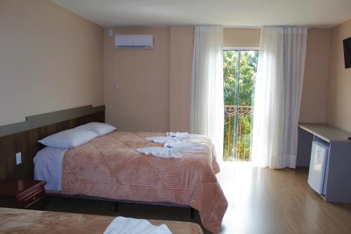 Postel nebo postele na pokoji v ubytování Pousada Essência Serrana Gramado