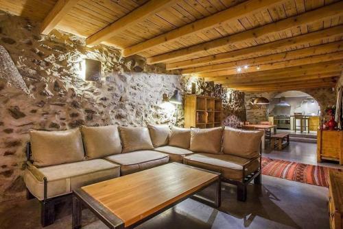 a living room with a couch and a table at Подковите in Karlovo
