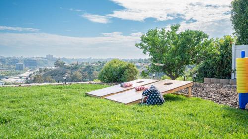 a person sitting on a bench in the grass at Home Ensuite With Panoramic City View in San Diego