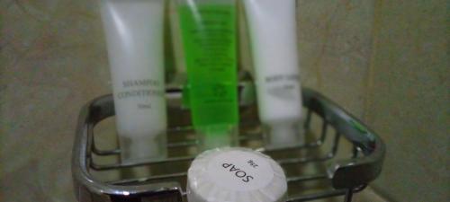 a toothbrush holder with three toothbrushes in it at Joyous AP Guest House in Aburi