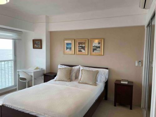 a bedroom with a large bed with two pillows at Villa Marbella by Potenza Rentals in Santo Domingo