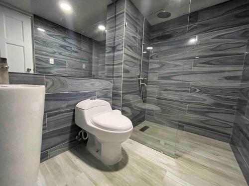 a bathroom with a toilet and a shower at Villa Marbella by Potenza Rentals in Santo Domingo