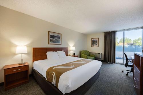 a hotel room with a large bed and a window at Quality Inn & Suites Canon City in Canon City