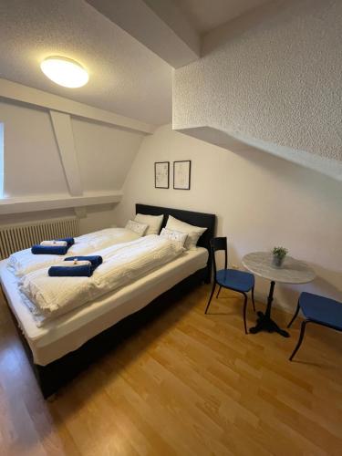 a bedroom with a large bed and a table at Haus zum Rütli in Chur