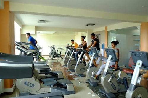 een groep mensen die trainen op cardioapparaten in een sportschool bij Golden Addis Hotel in Addis Ababa