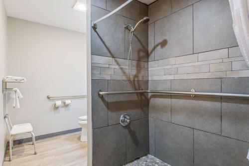 a shower with a glass door in a bathroom at SureStay Plus Hotel by Best Western Sevierville in Sevierville