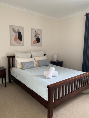 a bedroom with a large bed with blue curtains at 9/20 Apollo Quay Apartment in Mandurah