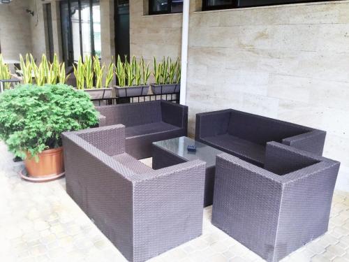 two wicker boxes sitting next to some plants at Apart-Hotel Panorama Sea LUX in Primorsko