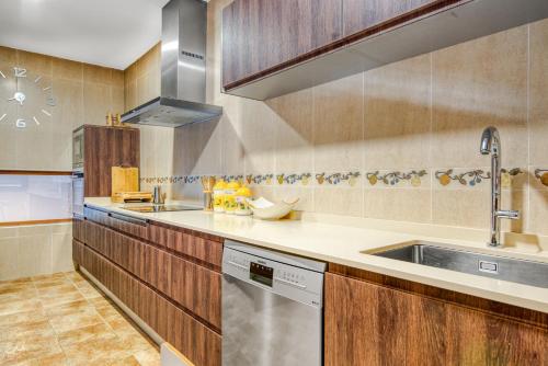 a kitchen with a sink and a dishwasher at Luxe Villa, Pool, Mountain views, BBQ, Sky, in Miraflores de la Sierra