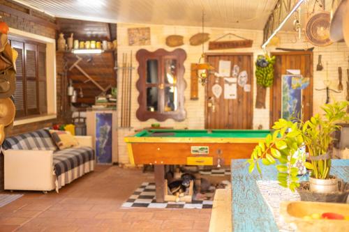 a living room with a pool table in it at Cabanna Hostel in Candelária
