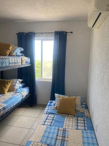 two bunk beds in a room with a window at Marina Diamante in Acapulco