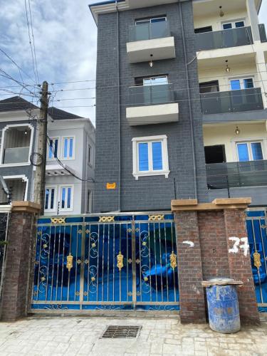 a blue gate in front of a building at Melford Homes in Lagos