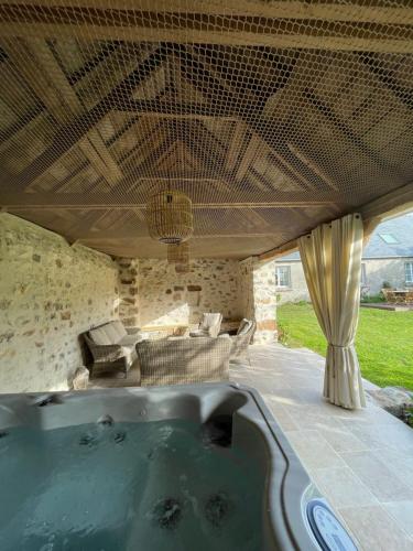 a hot tub in the middle of a patio at Les Cottages du Manoir, Jacuzzi -Crozon in Crozon