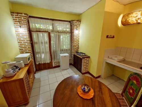 a kitchen with a wooden table in a room at Eco Suites Uxlabil Guatemala in Guatemala
