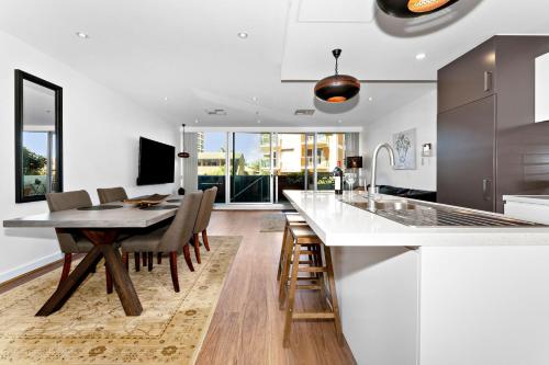 a kitchen and dining room with a table and chairs at Belle Escapes - Beach Retreat Townhouse Glenelg in Glenelg