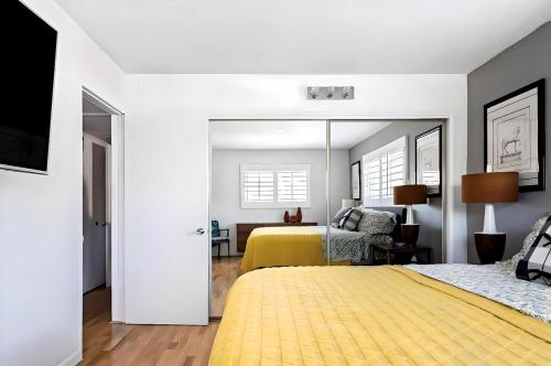 a bedroom with two beds and a yellow blanket at Pick from Curated Vintage Vinyl 3B-2B Lic 65597 in La Quinta