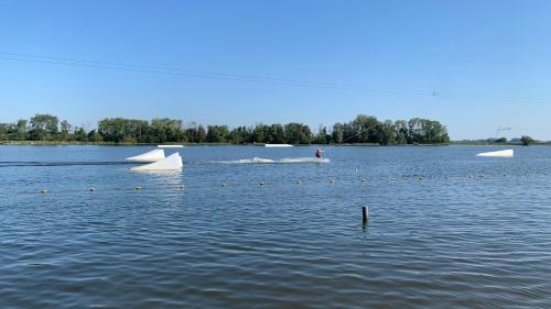 a person is on a boat in a lake at 't Paviljoenhûs bij Sneekermeer in Offingawier